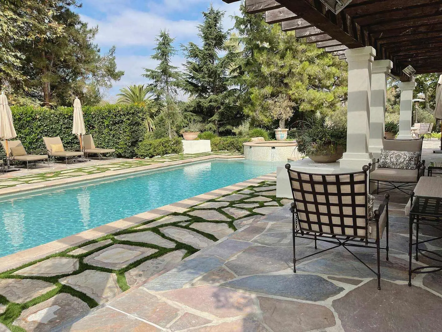 Custom natural stone turf tile patio and pool at a home in Del Mar, CA.