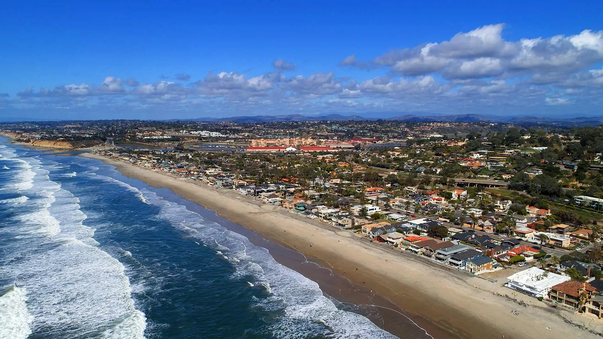 Del Mar, California view of coastline and high-end homes.