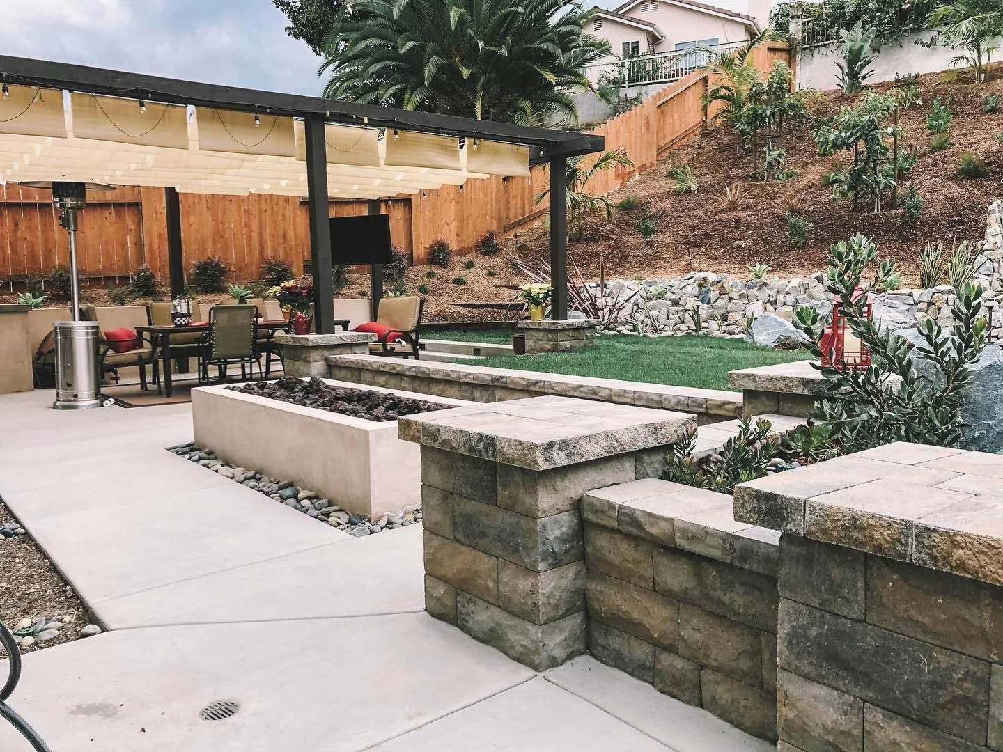 Custom patio area with seating and retaining walls near Carlsbad, CA.