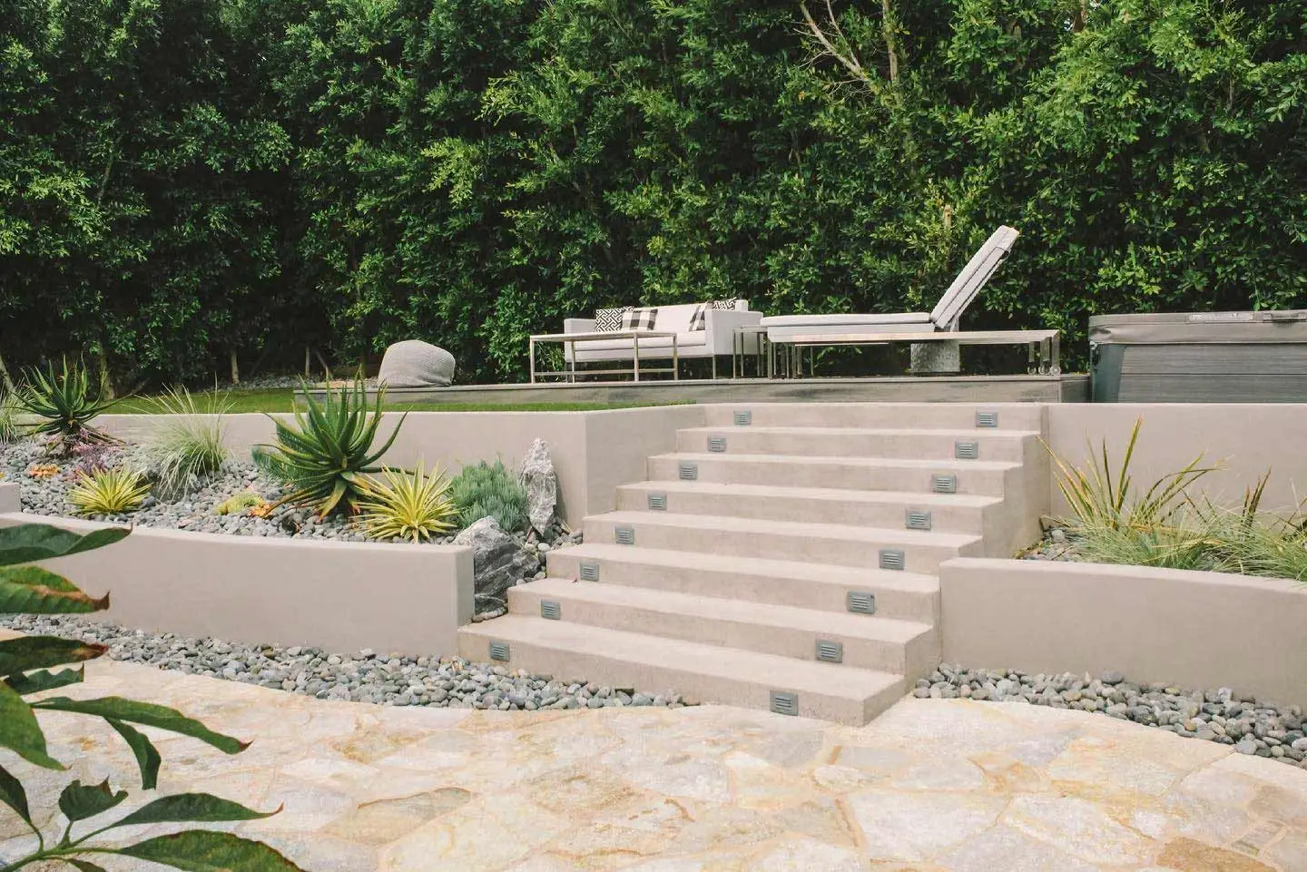 Custom patio with retaining wall and plantings in Rancho Santa Fe, CA.