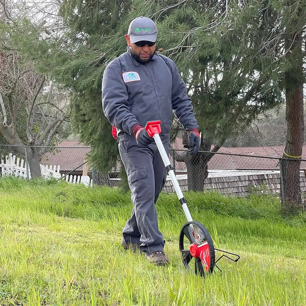 Landscape expert using equipment at a property in Carlsbad, CA.